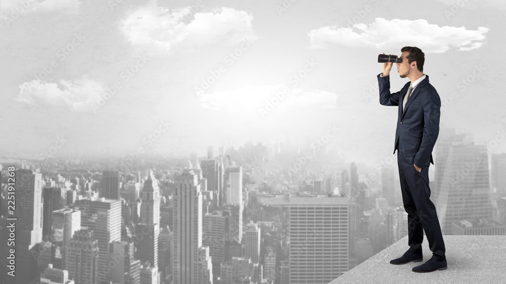 Businessman looking forward to a city with binoculars from skyscraper concept
Businessman looking forward to a city with binoculars from skyscraper concept