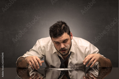 Young drunk man at his office with free dark copyspace