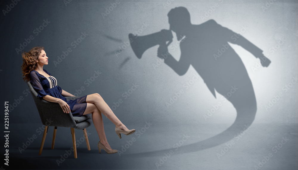 Fototapeta premium Dark shadow yelling with loudspeaker to elegant young lady