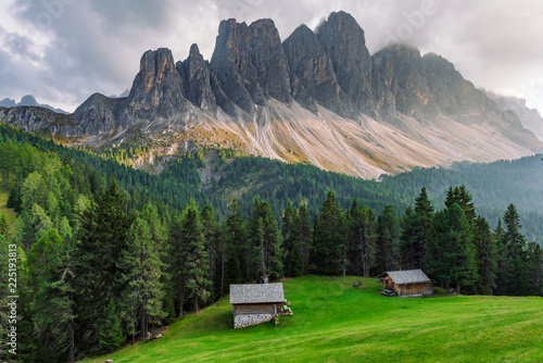 alpine village houses in St. Maddalena in Dolomites before sunset