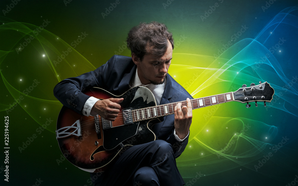 Obraz premium Serious classical guitarist with fabled sparkling wallpaper
