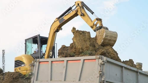 excavator loads a truck