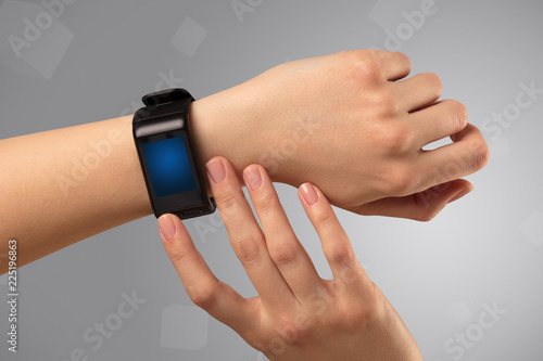 Female hand wearing smartwatch with free space on the screen