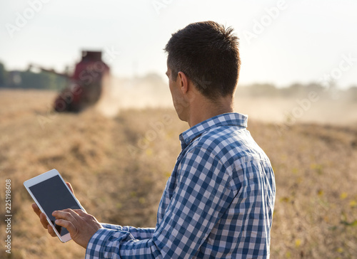 Farmer in soybean field during harvest