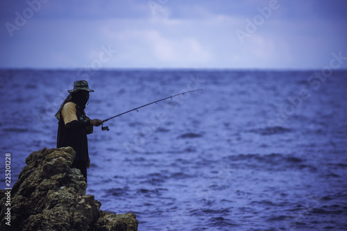 Man fishing in the evening, People use fishing rod and reel to catch a fish. Chill out lifestyle.