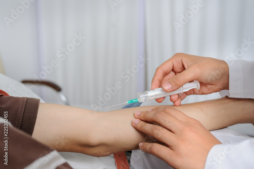 The doctor is injecting to patient in vein