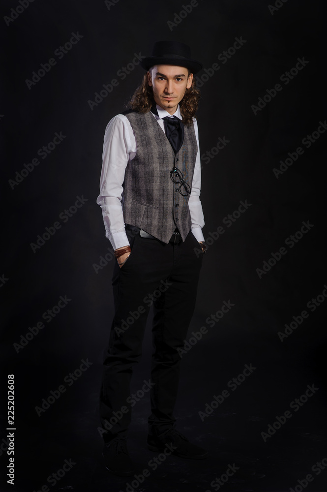 Fototapeta premium The handsome caucasian young man in a white shirt, suit and hat