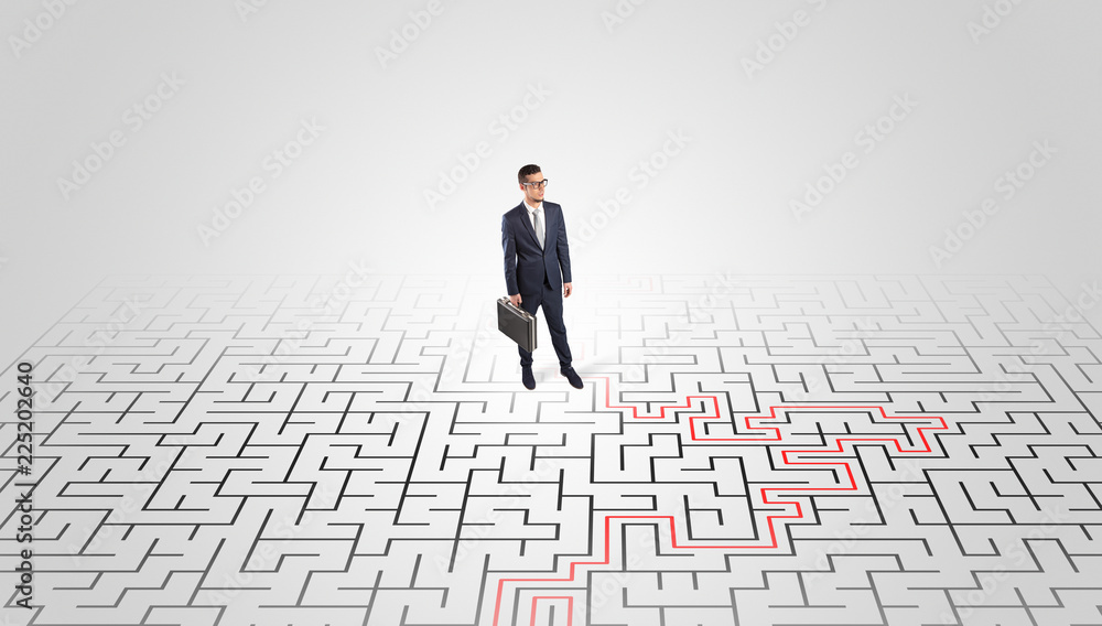Young entrepreneur standing in a middle of a labyrinth with the solution
Young entrepreneur standing in a middle of a labyrinth with the solution