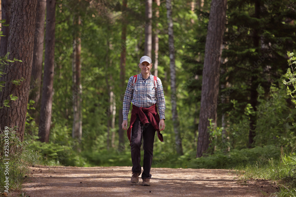 Tourist with backpack in a forest