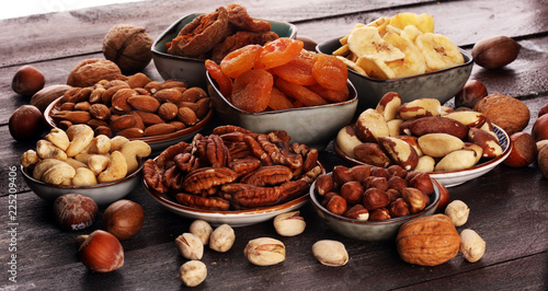 Fototapeta Naklejka Na Ścianę i Meble -  dried fruits and assorted nuts composition on rustic table