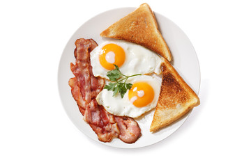 plate of fried eggs, bacon and toast isolated on white background