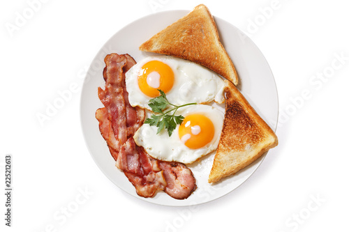 plate of fried eggs, bacon and toast isolated on white background