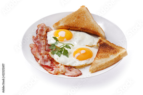 plate of fried eggs, bacon and toast on white background