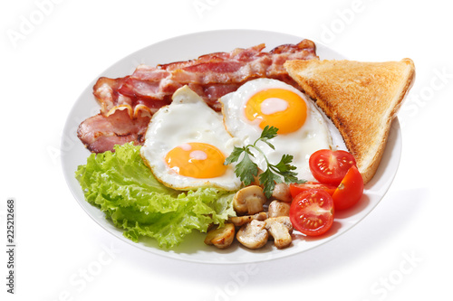plate of fried eggs, bacon, mushrooms and toast on white background