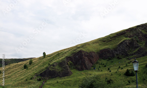 A trail going up a hill overlooking Edinburgh