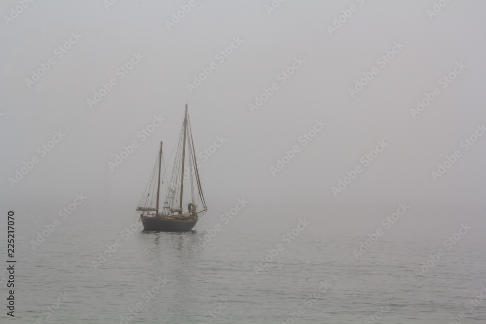 Tall ship sailing in the sea in fog