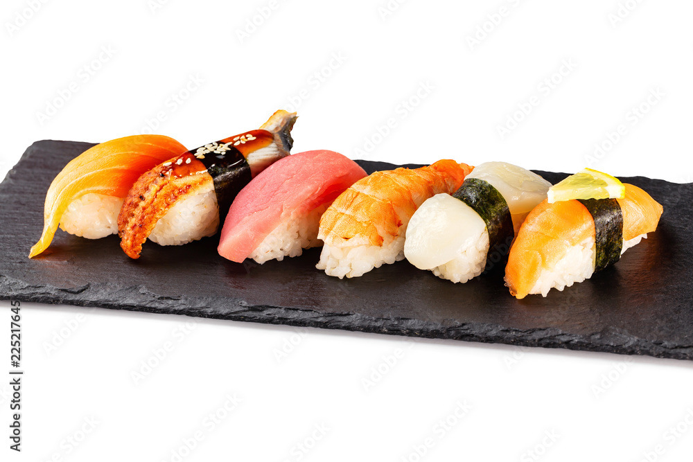 Set of japanese traditional sushi at stone plate isolated at white background. Set of japanese traditional sushi at stone plate isolated at white background.