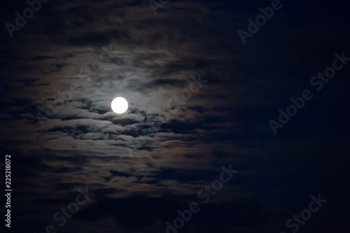 Mysterious night sky with moon and clouds.