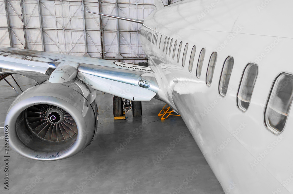 Fototapeta premium Passenger airplane on maintenance of jet engine and aircraft hangar.