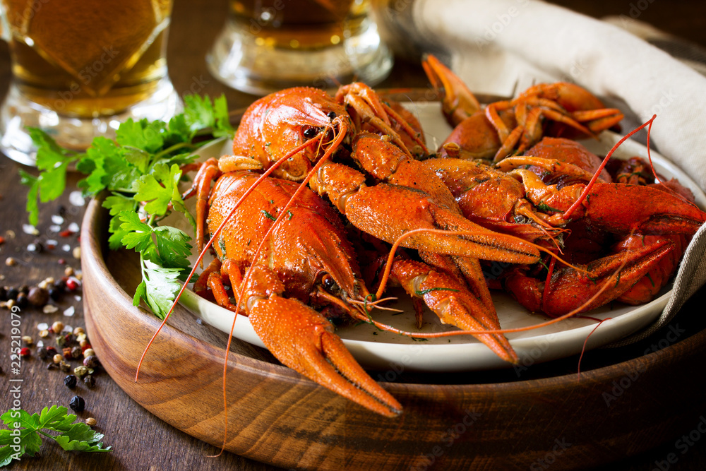 Boiled Crawfish and Fresh Beer in Beakers on a wooden table. Appetizer protein. Boiled Crawfish and Fresh Beer in Beakers on a wooden table. Appetizer protein.