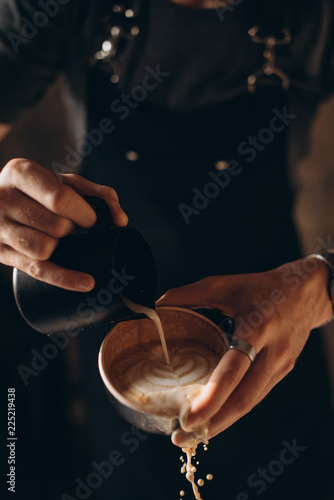 Barista pouring coffee into a cup