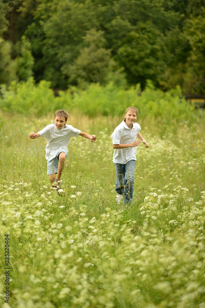Portrait of two brothers running in nature Portrait of two brothers running in nature