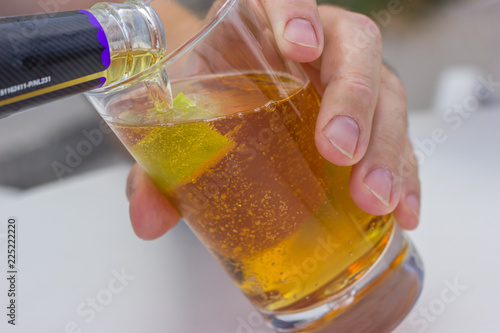 Wallpaper Mural carbonated beverage of amber color with lime in a glass goblet Torontodigital.ca