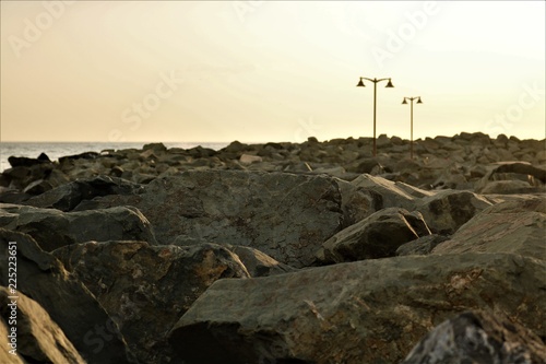 Rocky beach and lighting poles