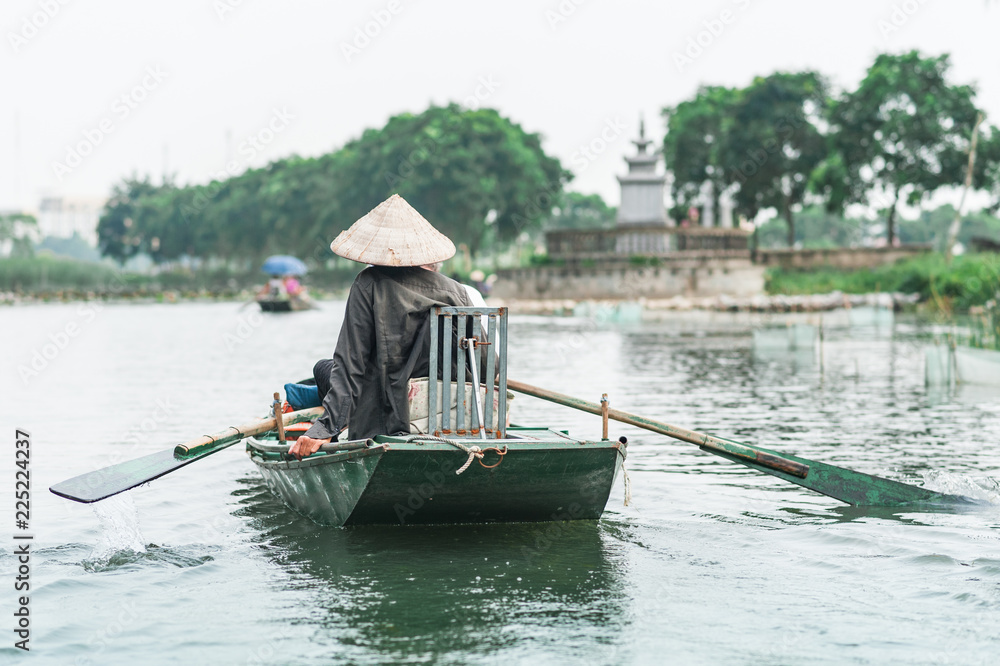 Boat ride from Vung Tram Pier. Traditional paddle-boat trip lets the tourists truly appreciate the serenity and beauty of nature along the Ngo Dong River. The grottoes and limestone karsts of Tam Coc.