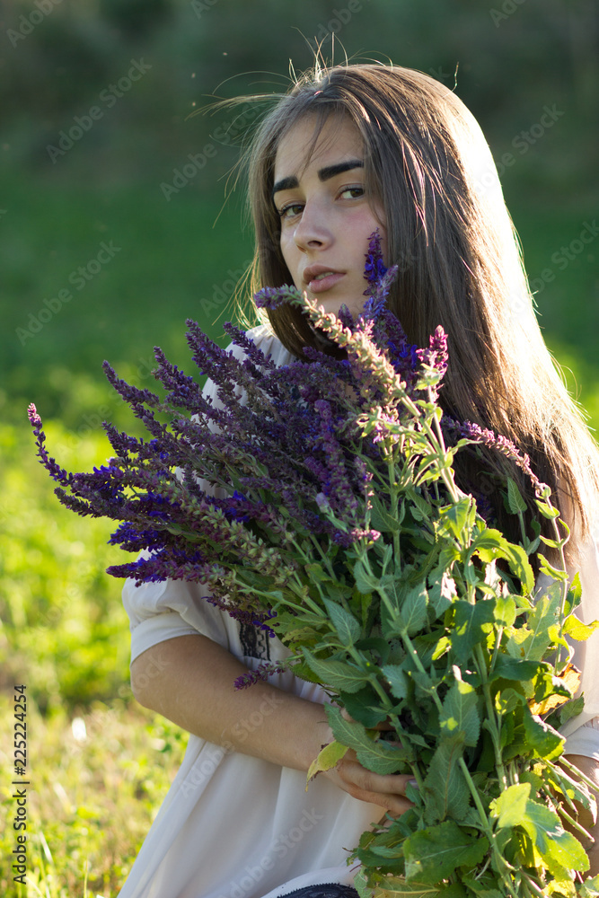 Beautiful girl iwith lavender bouquet and retro dress in the field. Girl collect lavender. Soft focus Beautiful girl iwith lavender bouquet and retro dress in the field. Girl collect lavender. Soft focus