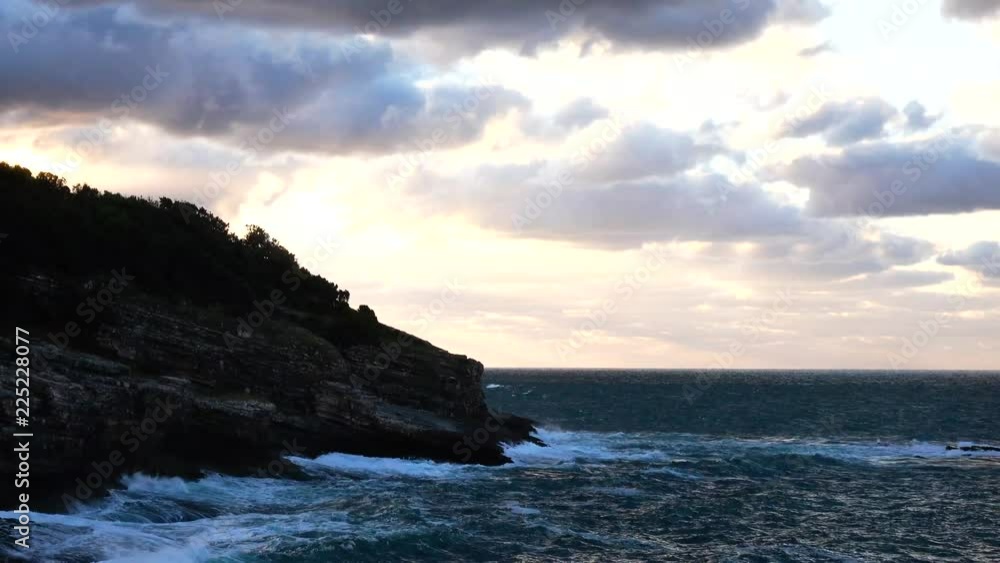 waves hitting rocky cliff horizontal view waves hitting rocky cliff horizontal view