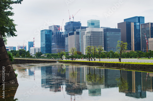 Business centre in Tokyo. Urban view. Skyscrapers reflecting in pond. Japanese park near the city centre.