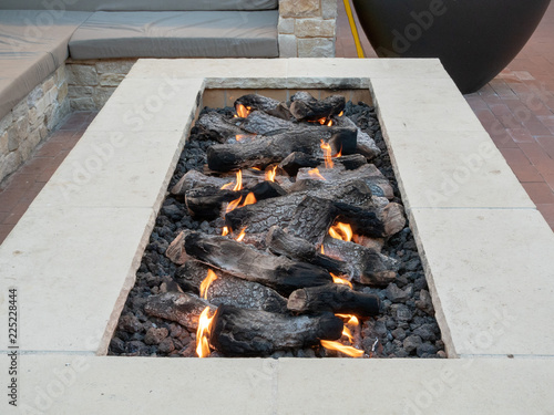 Long, rectangular fire pit sitting in open air plaza
