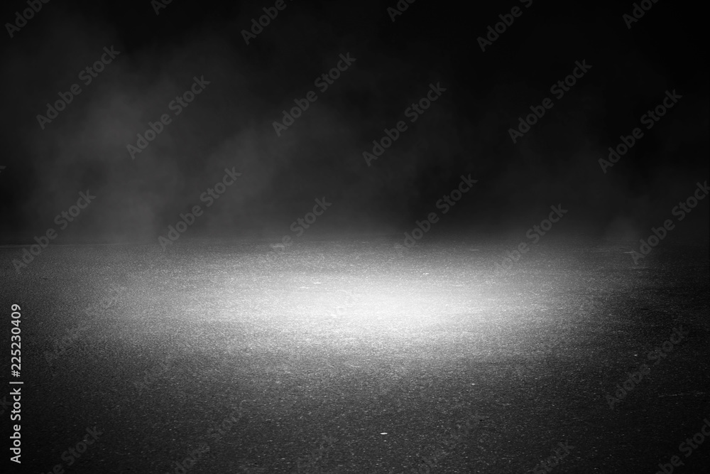 Background of an empty dark street, wet asphalt. Spotlight, smoke, fog