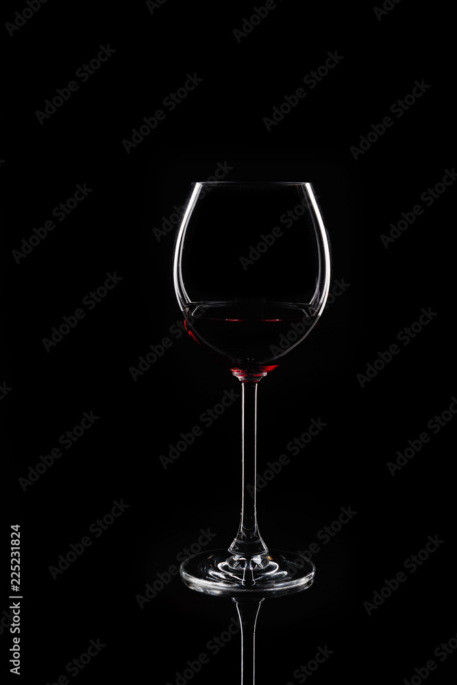 Glass of red wine at black background