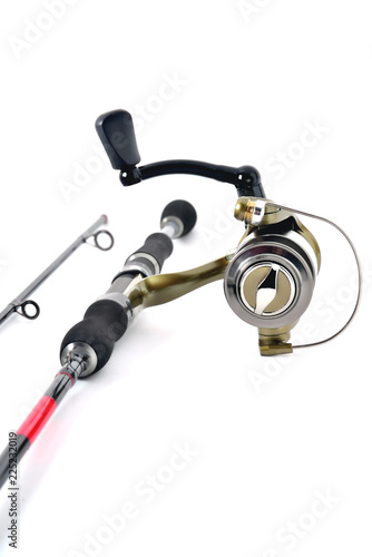 fishing reel on a fishing rod, white background close-up