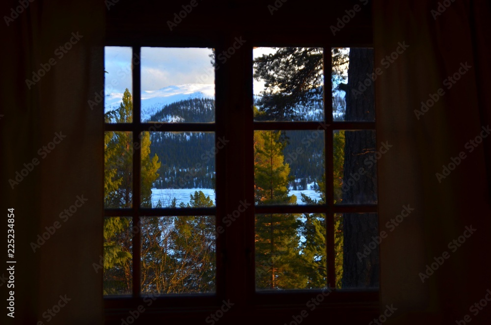 Frozen lake through window in Norway Frozen lake through window in Norway