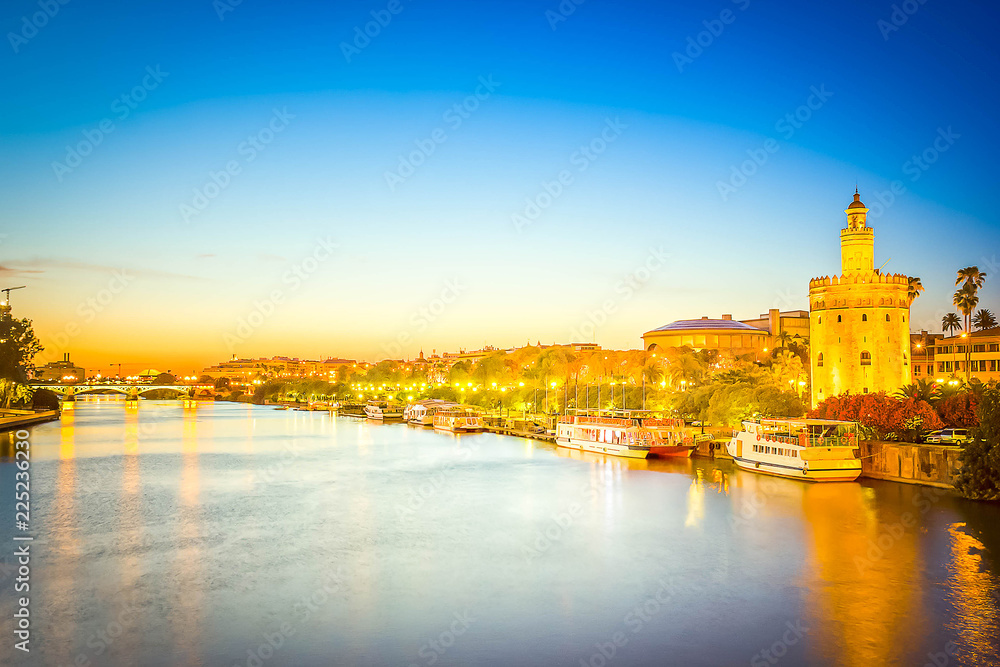 cityscape with river of Sevilla at night, Spain, toned