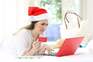 Confused woman paying online on christmas holidays