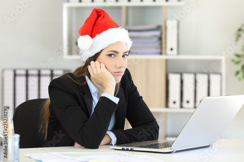 Sad office worker working in christmas time