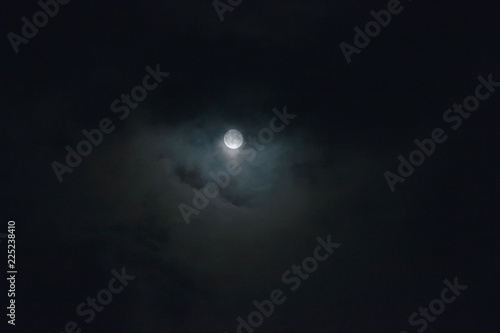 Autumn full moon surrounded with clouds