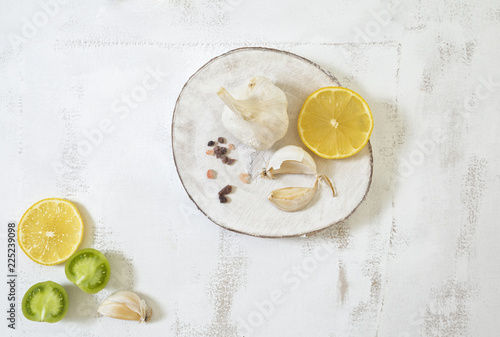 Garlic Cloves and Bulb on White Wood Slice