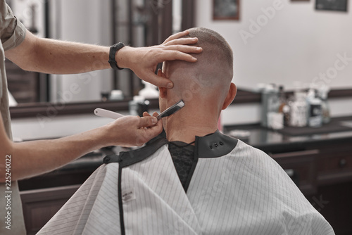 Haircut and hair styling in barbershop. Hair Care. Men's style and lifestyle. Barber brings a haircut and beard to his client.