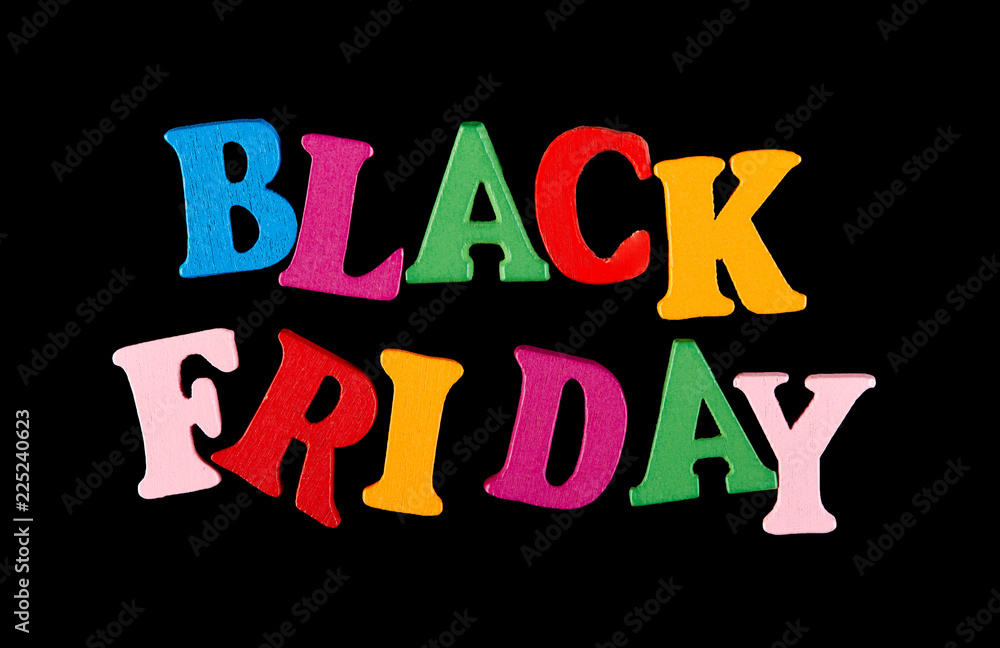 inscription in wooden letters Black Friday isolated on a black background. inscription in wooden letters Black Friday isolated on a black background.