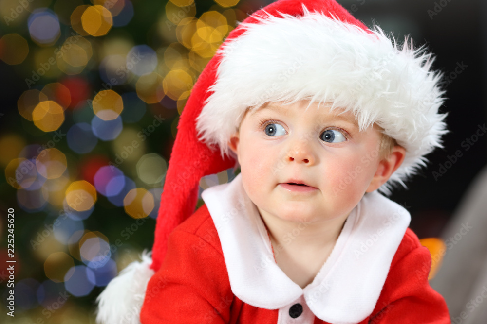 Astonished baby looking at side in christmas Astonished baby looking at side in christmas