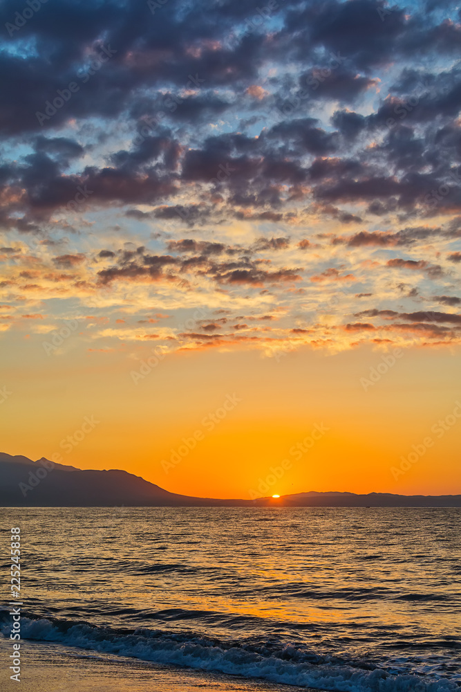 Naklejka premium Early morning , dramatic sunrise over sea and mountain. Photographed in Asprovalta, Greece.