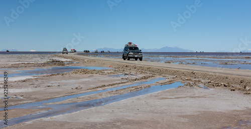 Uyuni, Bolivia: offroad vechicle driving through the Uyuni salt lake photo