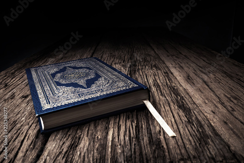 Photo Koran - holy book of Muslims ( public item of all muslims ) on the table , still