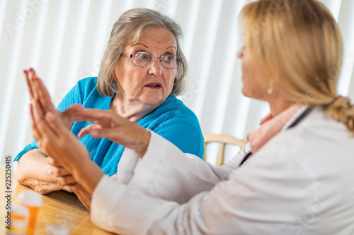 Female Doctor Talking with ...