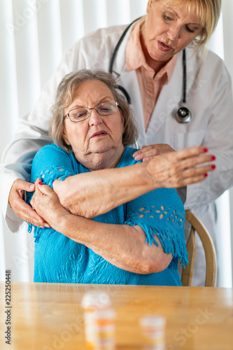 Female Doctor Helping Senio...